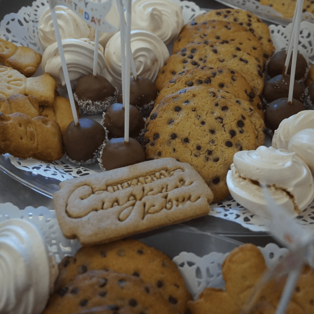 A plate with a variety of sweets. Includes chocolate biscuits, original cookies, chocolate creams